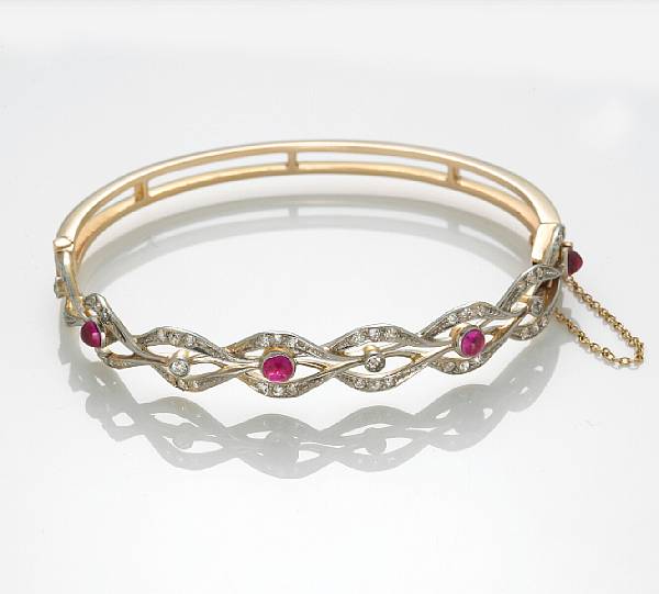 Appraisal: A ruby cabochon diamond and k bicolor gold bangle bracelet