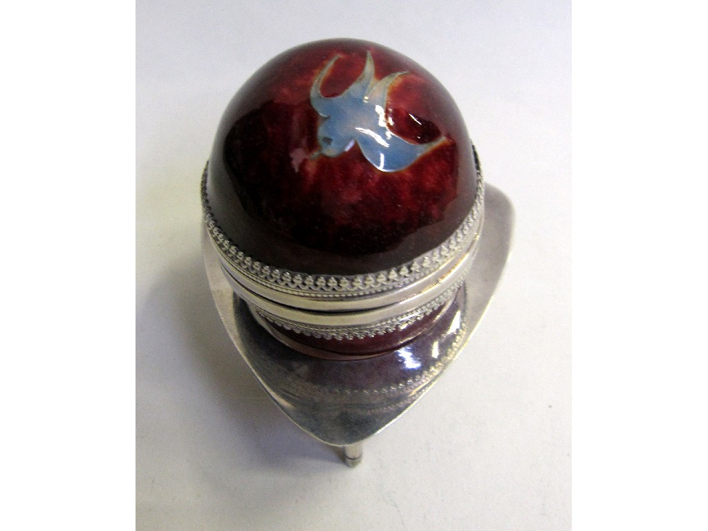 Appraisal: Red enamelled silver egg decorated with a swallow in a