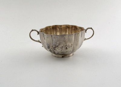 Appraisal: A silver two handled quaich plain circular form the side