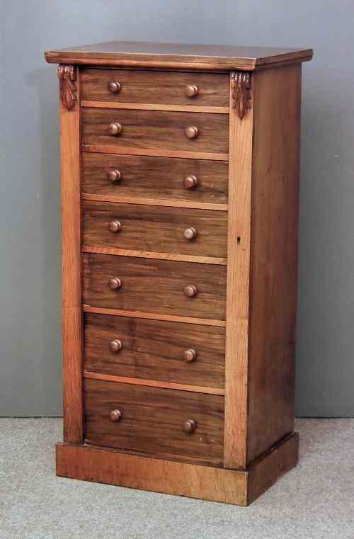 Appraisal: A Victorian rosewood Wellington chest with carved scroll brackets fitted