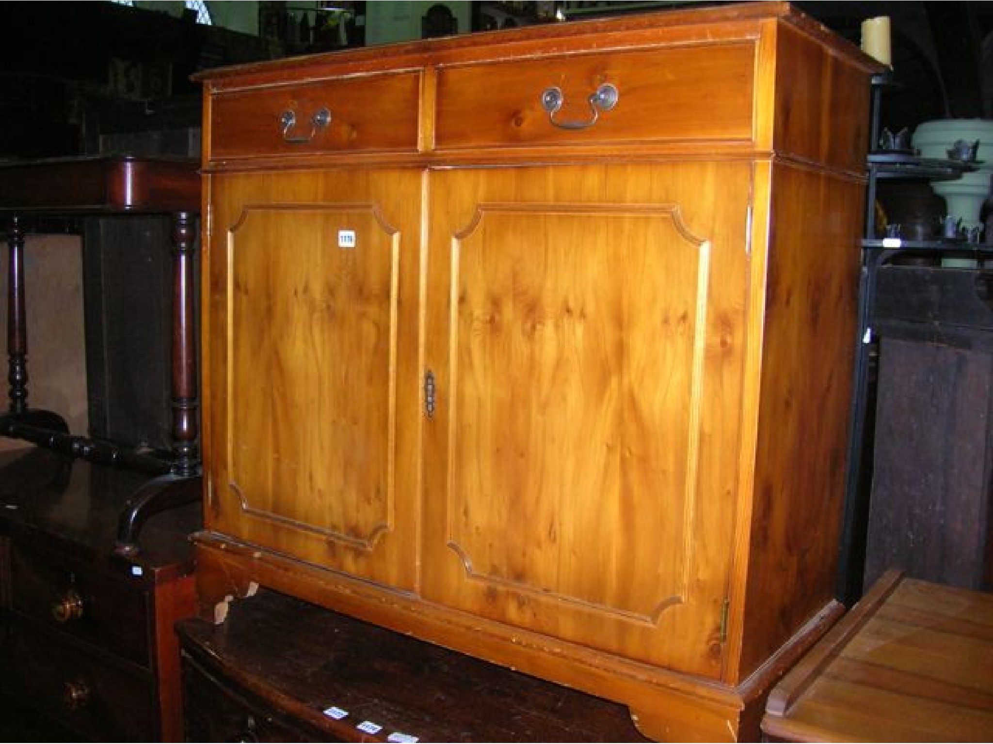 Appraisal: A reproduction yew wood veneered side cupboard in the Georgian