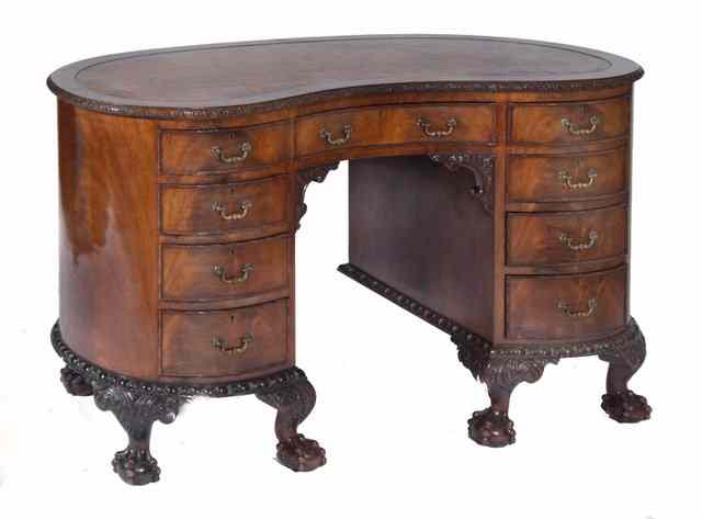 Appraisal: AN EDWARDIAN CHIPPENDALE STYLE MAHOGANY PEDESTAL DESK of kidney shaped