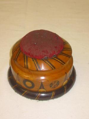 Appraisal: A VICTORIAN TREEN PIN CUSHION of moulded circular form inlaid