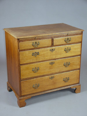 Appraisal: A George III oak chest of drawers with brushing slide