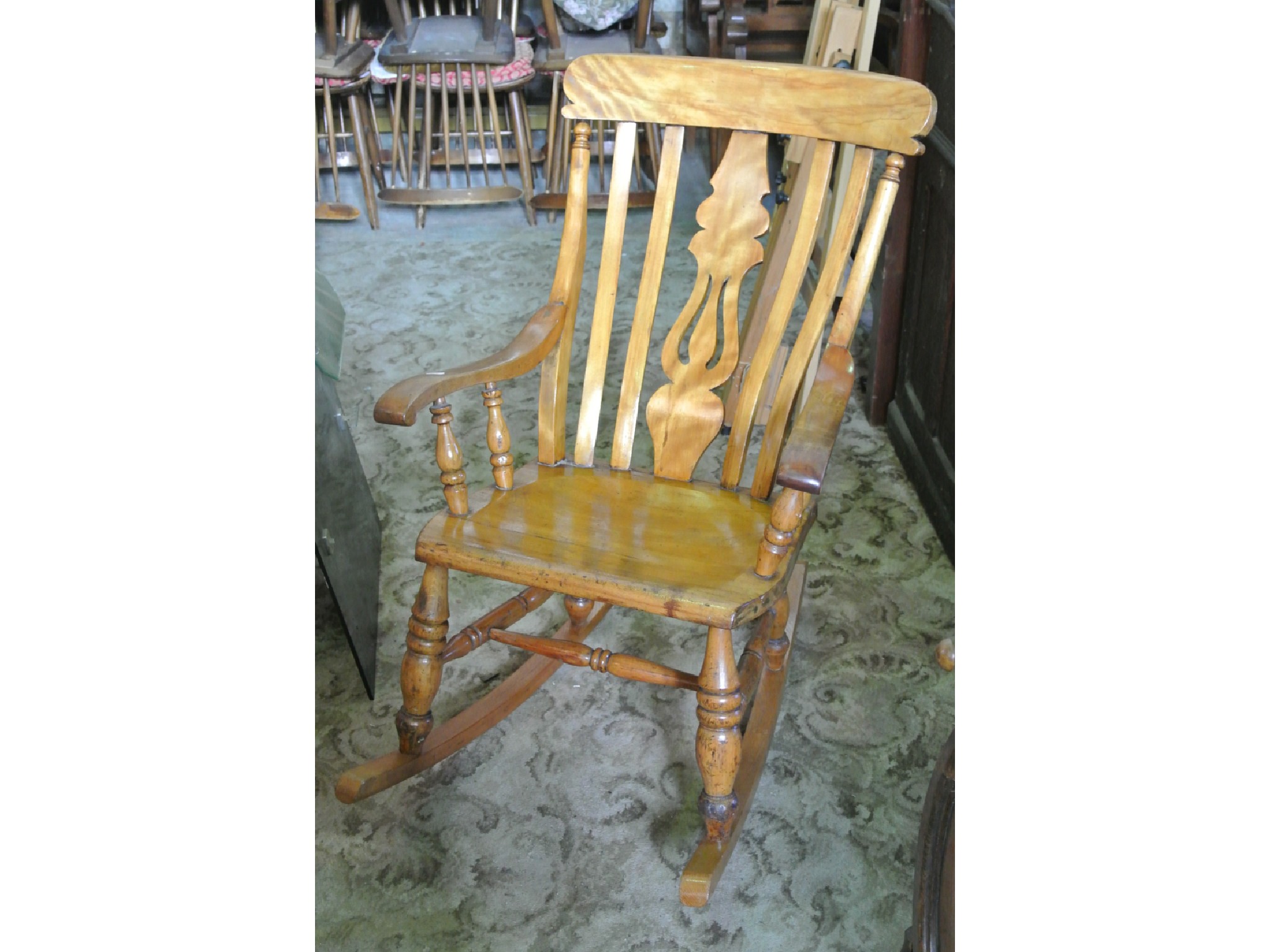 Appraisal: A th century Windsor style rocking chair principally in birchwood