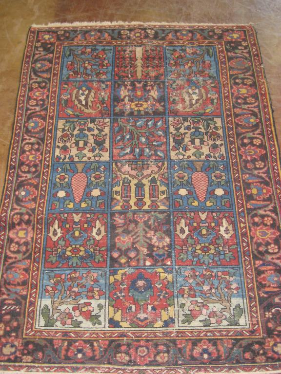 Appraisal: A bordered Oriental Rug with eighteen panels of cones botch