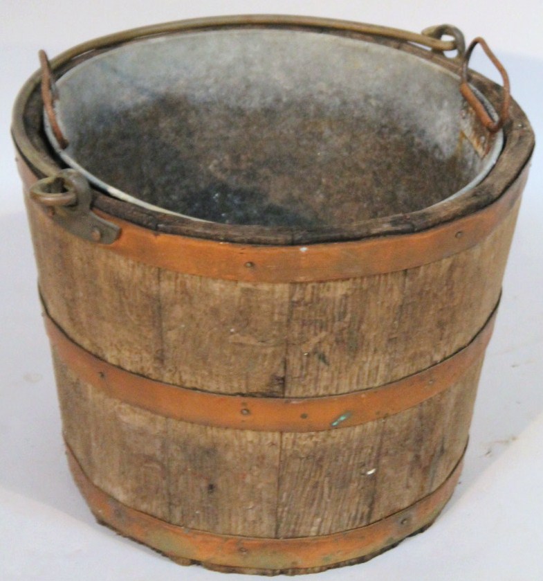 Appraisal: A thC oak coopered bucket with swing metal handle and