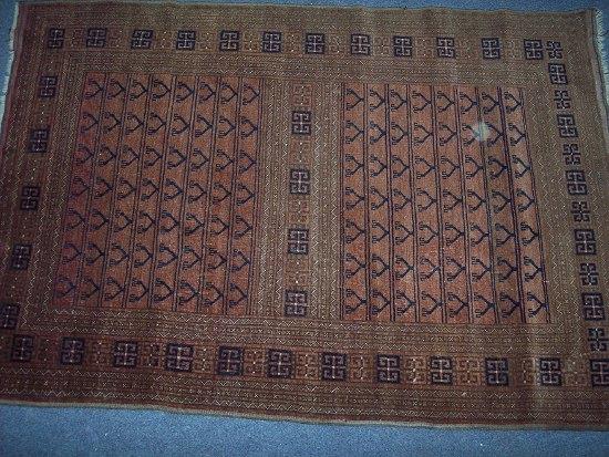 Appraisal: An Afghan rug with geometric centre and twin rows of