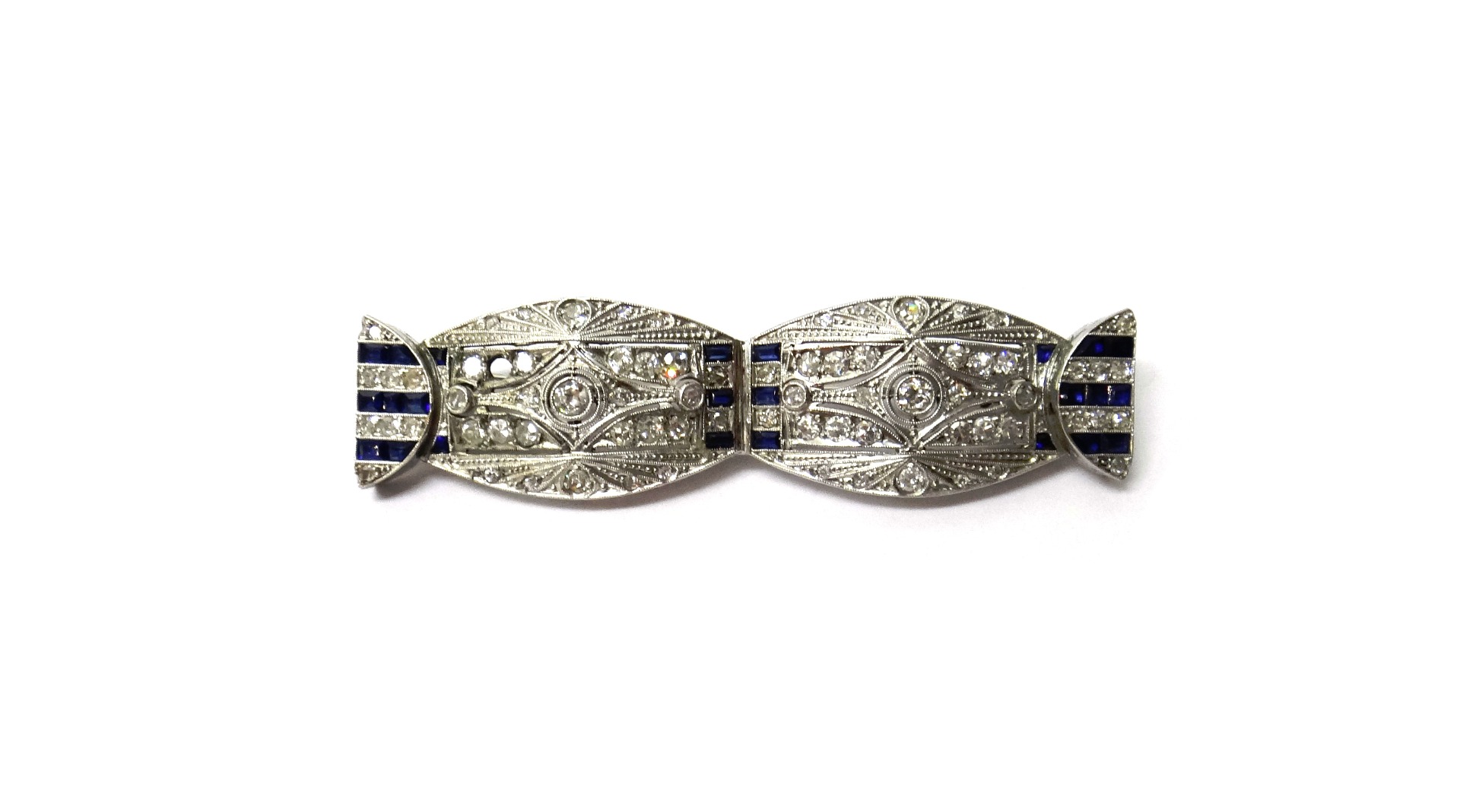 Appraisal: A diamond and synthetic sapphire set brooch of twin oval