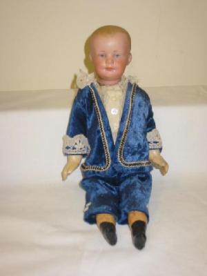 Appraisal: An Armand Marseille bisque head boy doll with blue intaglio