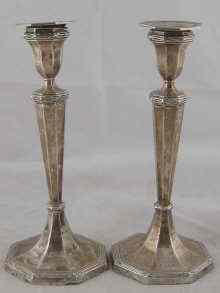 Appraisal: A pair of hallmarked silver candlesticks with ribbon and reed