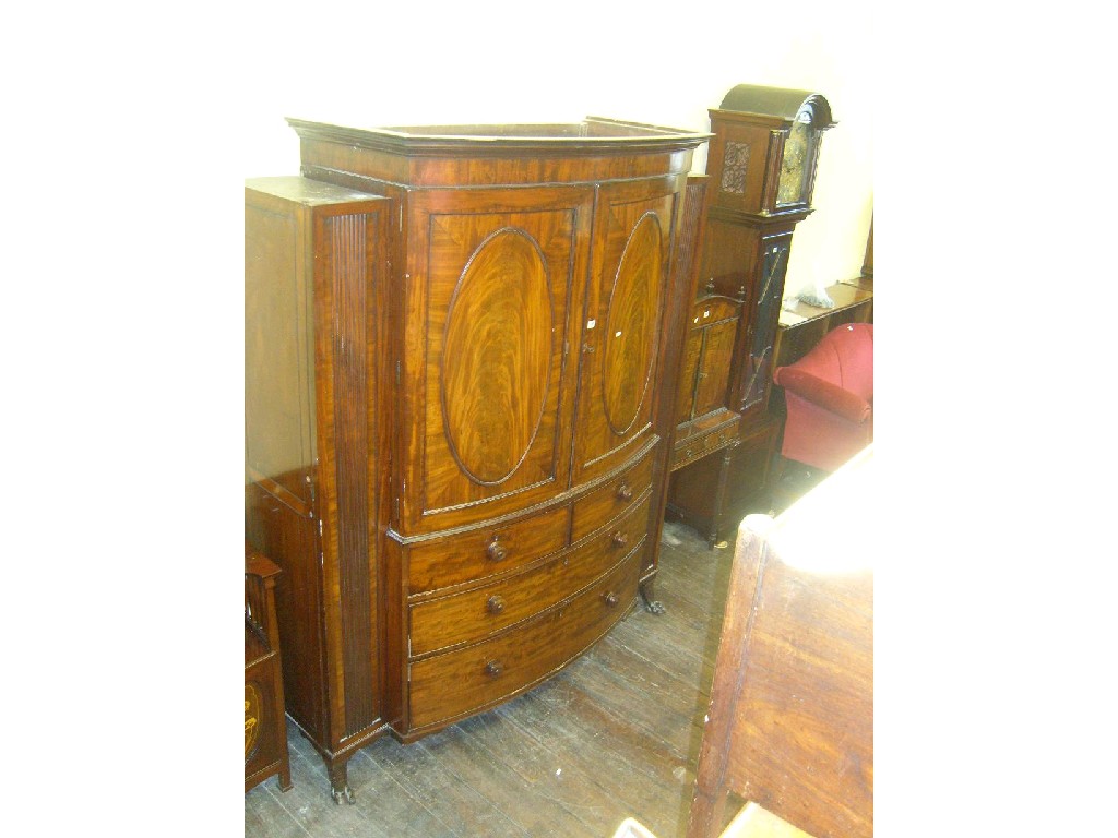 Appraisal: A Regency mahogany bow front linen press the upper section