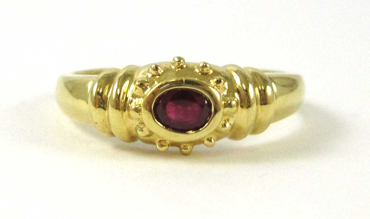 Appraisal: RUBY AND EIGHTEEN KARAT YELLOW GOLD RING bezel set with