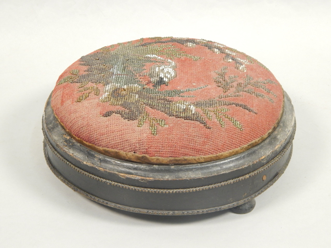 Appraisal: A Victorian ebonised and gilt metal foot stool with a