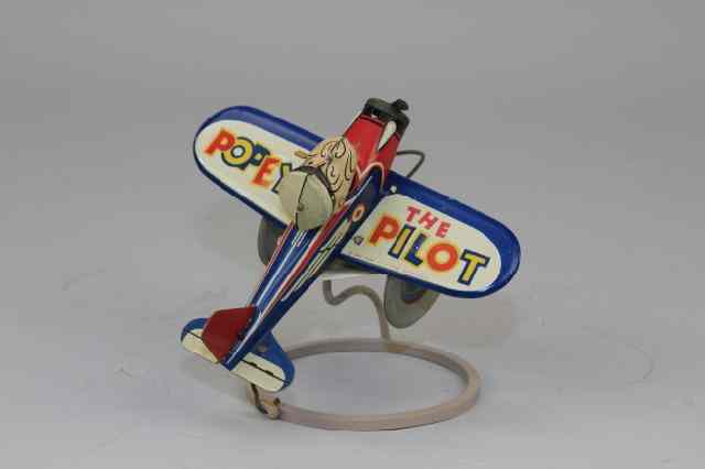 Appraisal: MARX POPEYE PILOT AIRPLANE Lithographed tin colorful graphics overall features