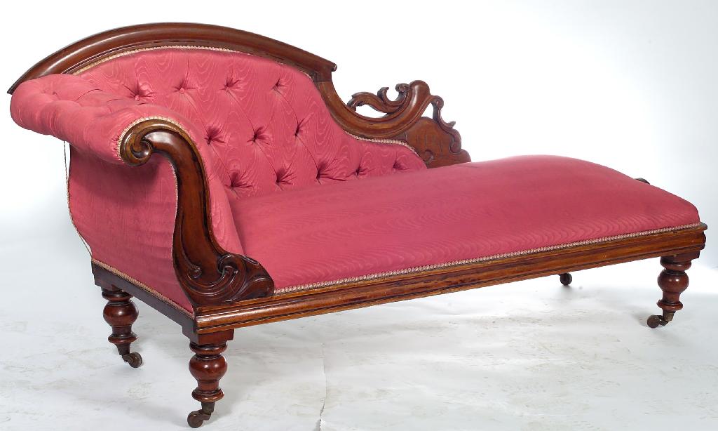 Appraisal: VICTORIAN MAHOGANY CHAISE LONGUE with leaf-carved scrolling frame and deep-buttoned