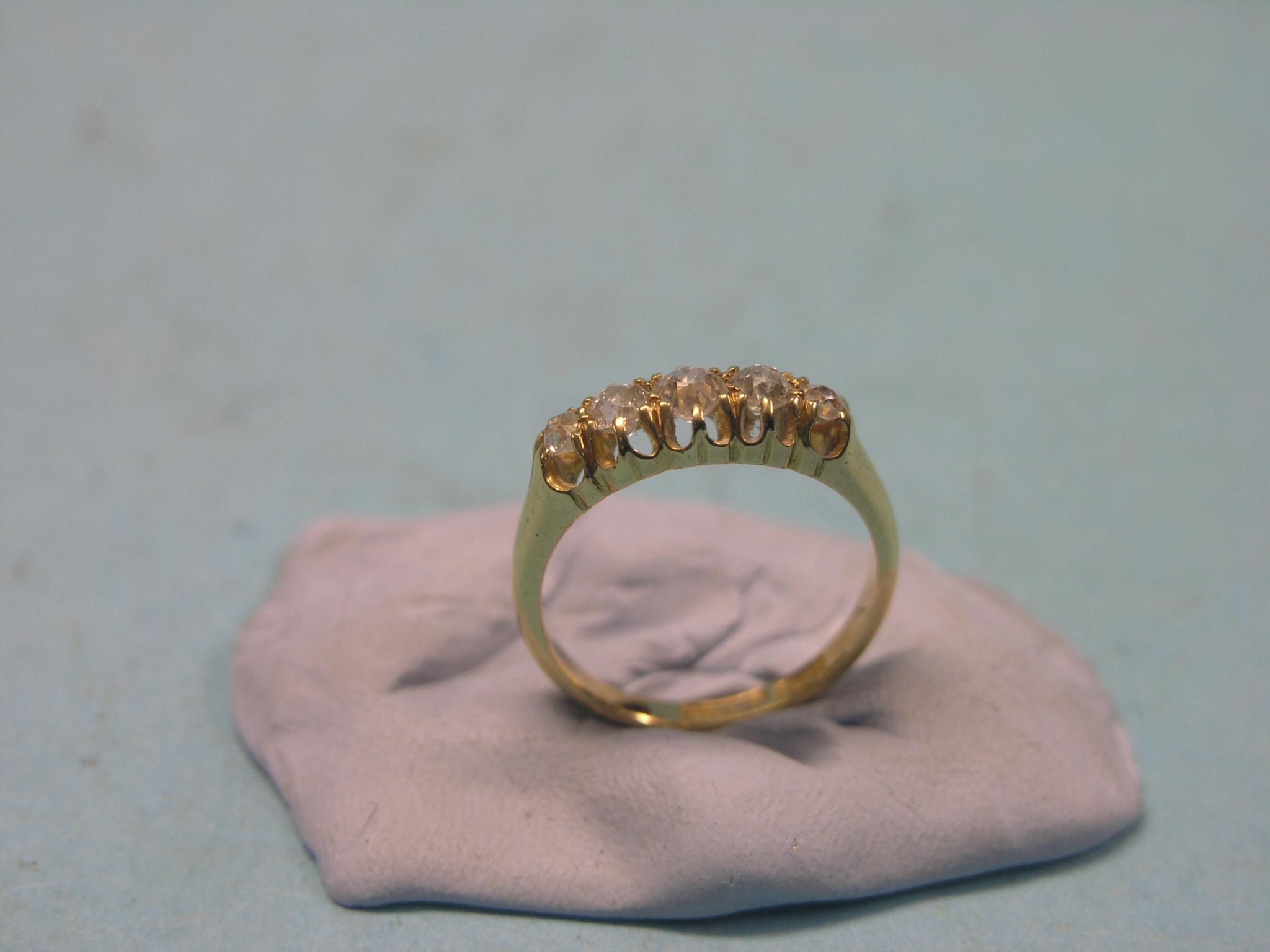 Appraisal: An ct gold and diamond half-hoop ring five graduated diamonds