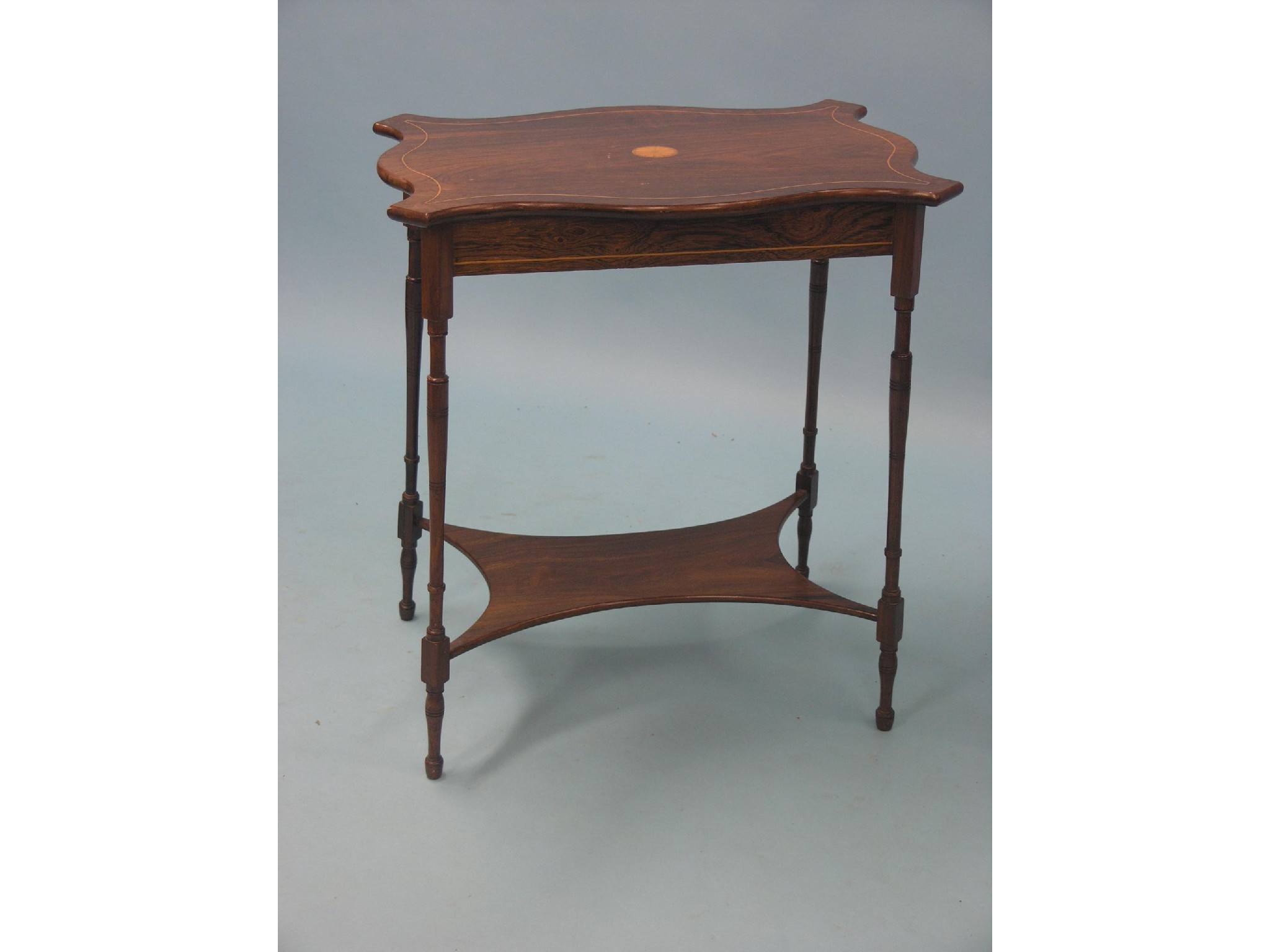 Appraisal: An Edwardian inlaid rosewood occasional table serpentine-shaped top on slim