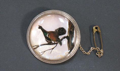 Appraisal: A CIRCULAR SCOTTISH INTAGLIO BROOCH depicting a capercally sitting on