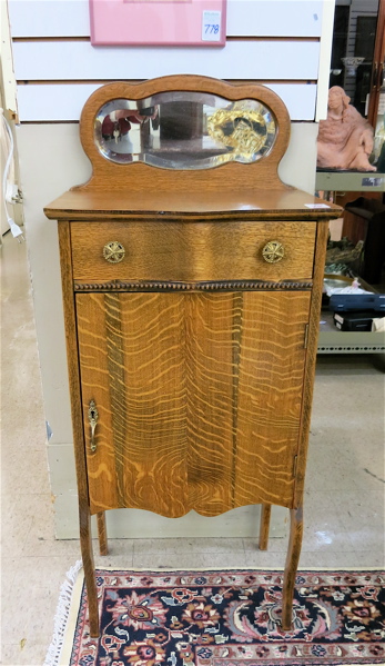 Appraisal: LATE VICTORIAN OAK MUSIC CABINET American c with mirror crest