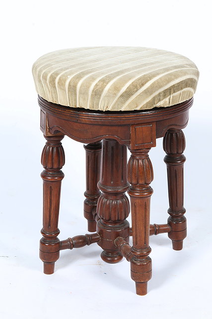 Appraisal: A VICTORIAN WALNUT CIRCULAR ADJUSTABLE PIANO STOOL standing on turned