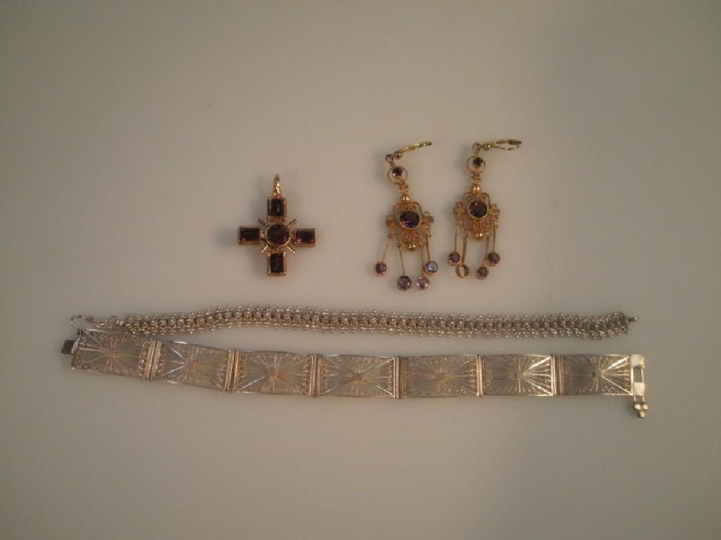 Appraisal: Two white metal bracelets a costume crucifix and a pair