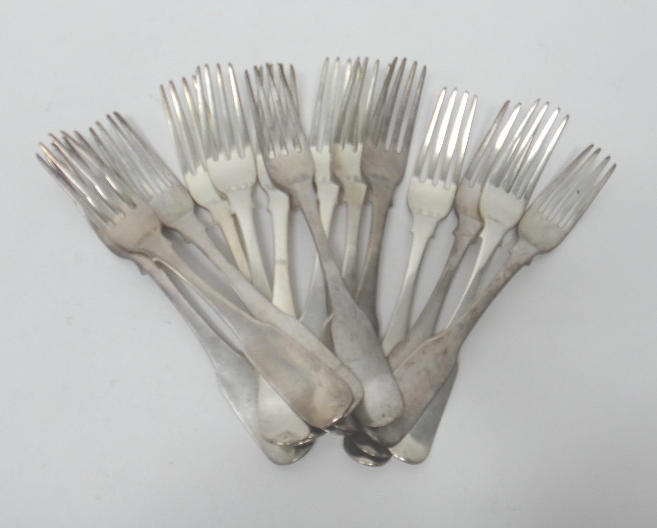 Appraisal: Fourteen Irish silver fiddle pattern table forks each crest engraved