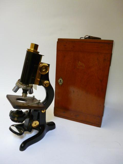 Appraisal: A BLACK LACQUERED AND BRASS MONOCULAR MICROSCOPE with rack and