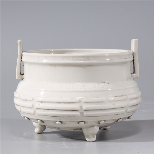 Appraisal: Chinese white glazed porcelain tripod censer with molded handles and