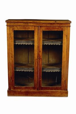 Appraisal: A Victorian walnut bookcase the glazed doors enclosing two adjustable