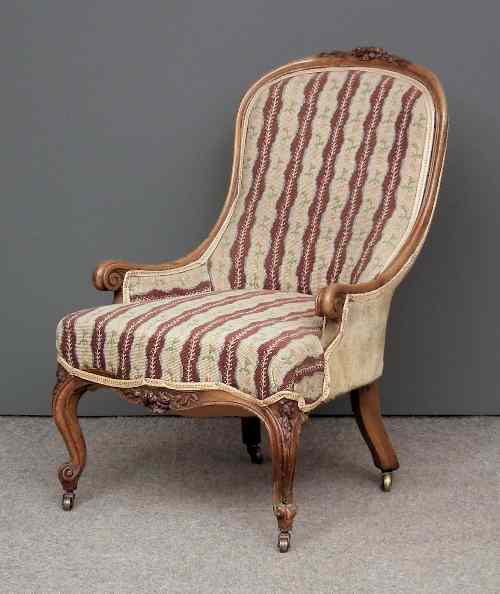 Appraisal: A Victorian walnut framed nursing chair the shaped and moulded