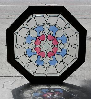 Appraisal: Large framed stained glass window having an octagonal form decorated