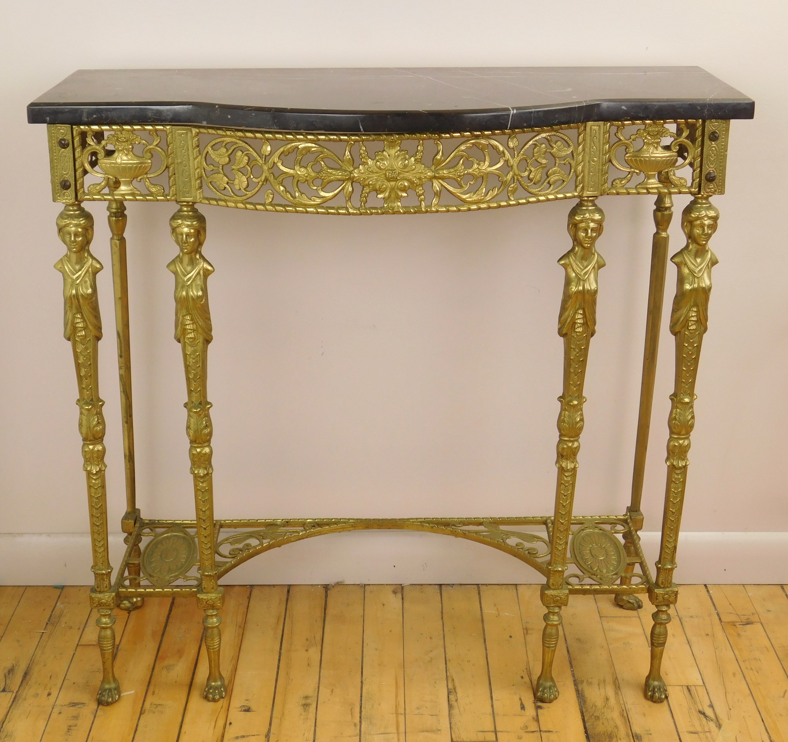 Appraisal: Gilt iron hall stand with black marble top caryatid supports