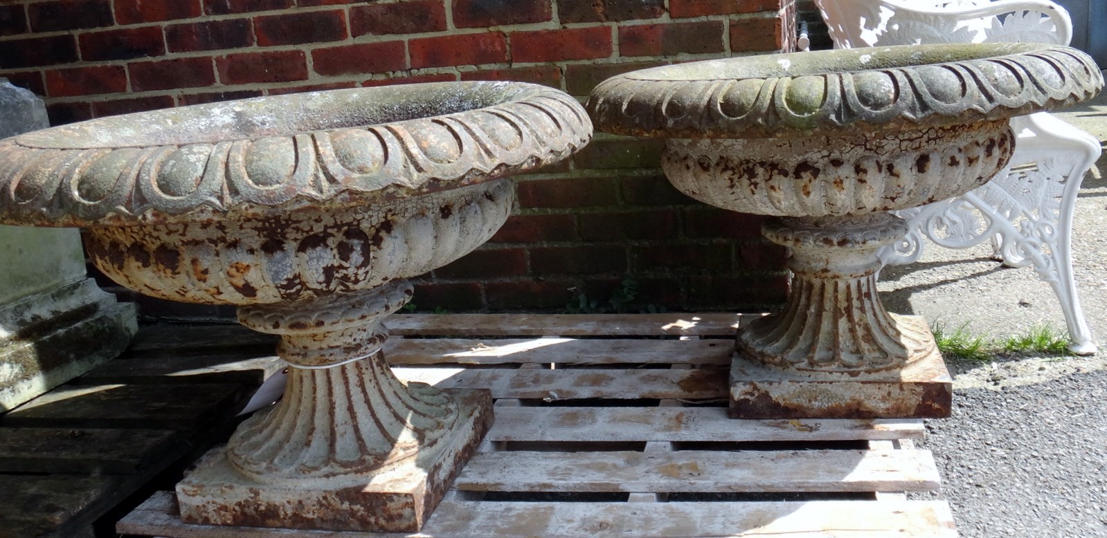 Appraisal: A large pair of cast iron garden urns with fluted