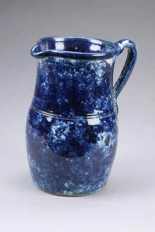 Appraisal: BLUE SPONGED PITCHER Stoneware with dark cobalt color Applied handle