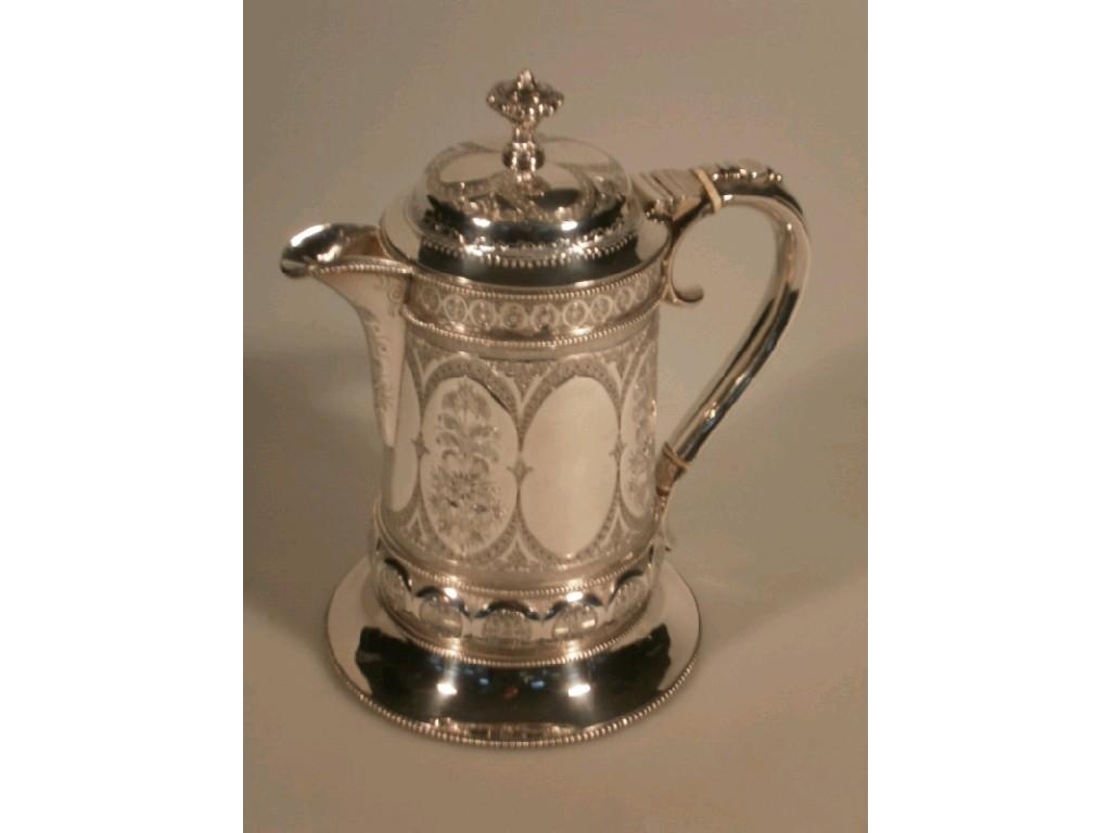 Appraisal: A silver plated cylindrical coffee pot with engraved repouss decoration