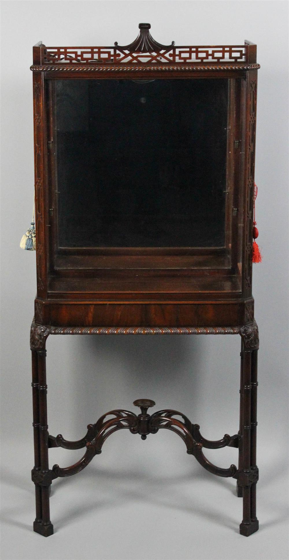 Appraisal: CHINESE CHIPPENDALE STYLE MAHOGANY LIGHTED VITRINE CABINET pierced gallery atop