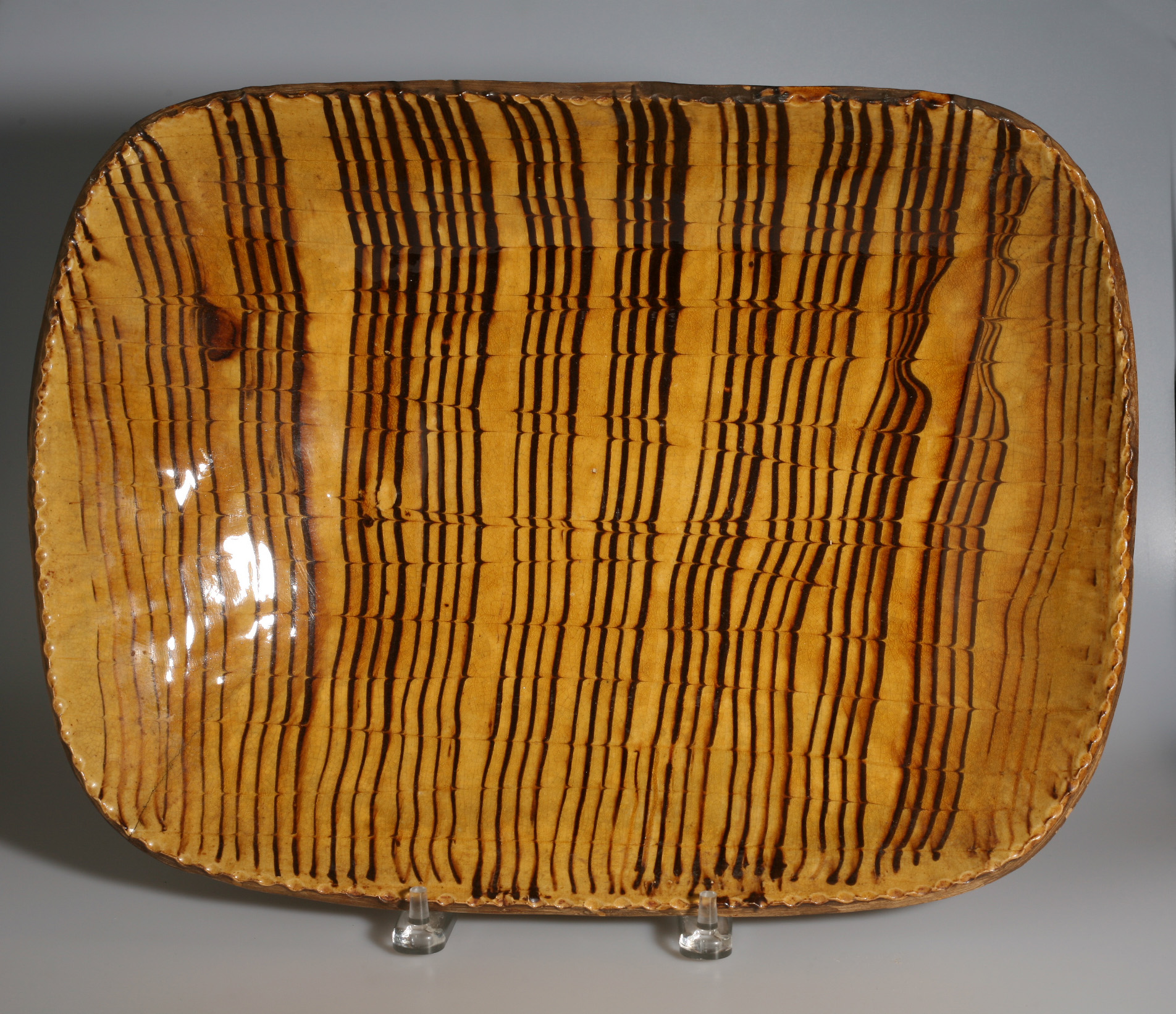 Appraisal: ENGLISH SLIP-DECORATED RECTANGULAR LOAF PAN NINETEENTH CENTURY Combed in dark