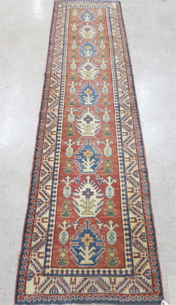 Appraisal: HAND KNOTTED ORIENTAL RUNNER Pakistani-Caucasian overall geometric design on rose