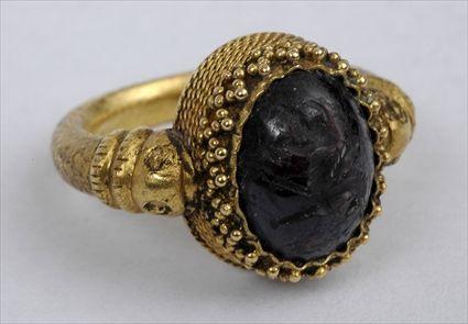 Appraisal: EARLY PERSIAN GOLD RING WITH GARNET INCISED WITH GRIFFIN Size