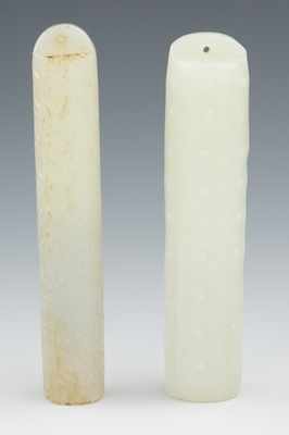 Appraisal: Two Carved Jade Toggles Each carved in a light celadon