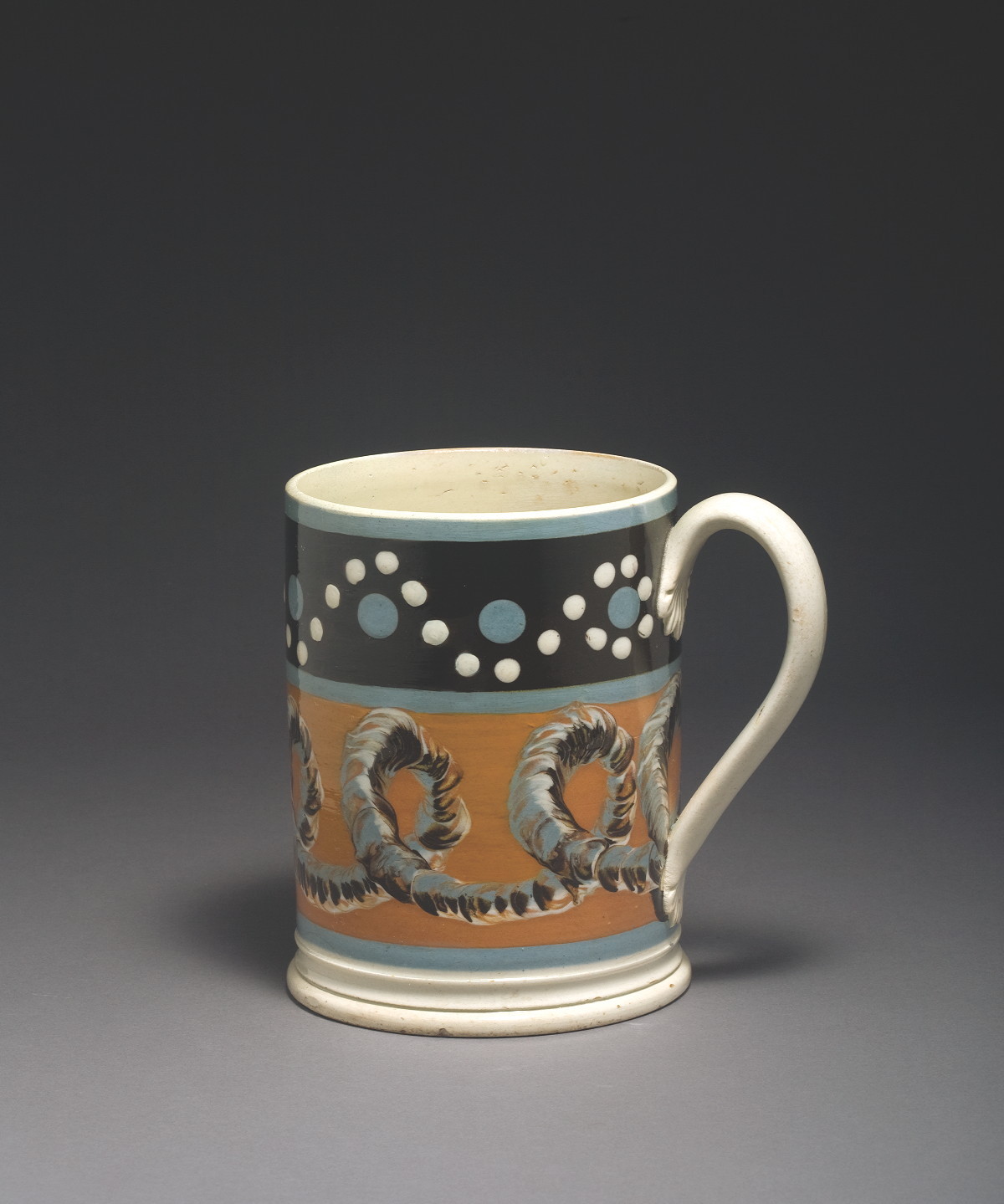 Appraisal: BRITISH PEARLWARE MOCHAWARE MUG CIRCA Surrounded by a blue dark