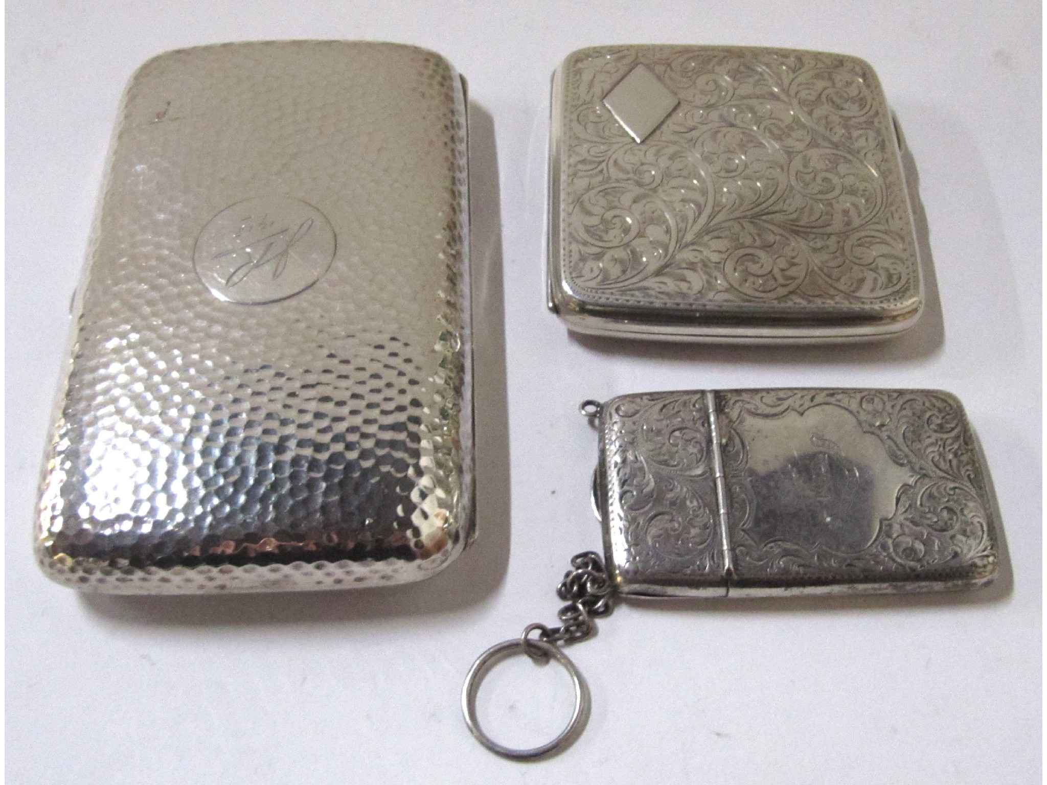 Appraisal: A lot comprising two silver cigarette cases and a silver