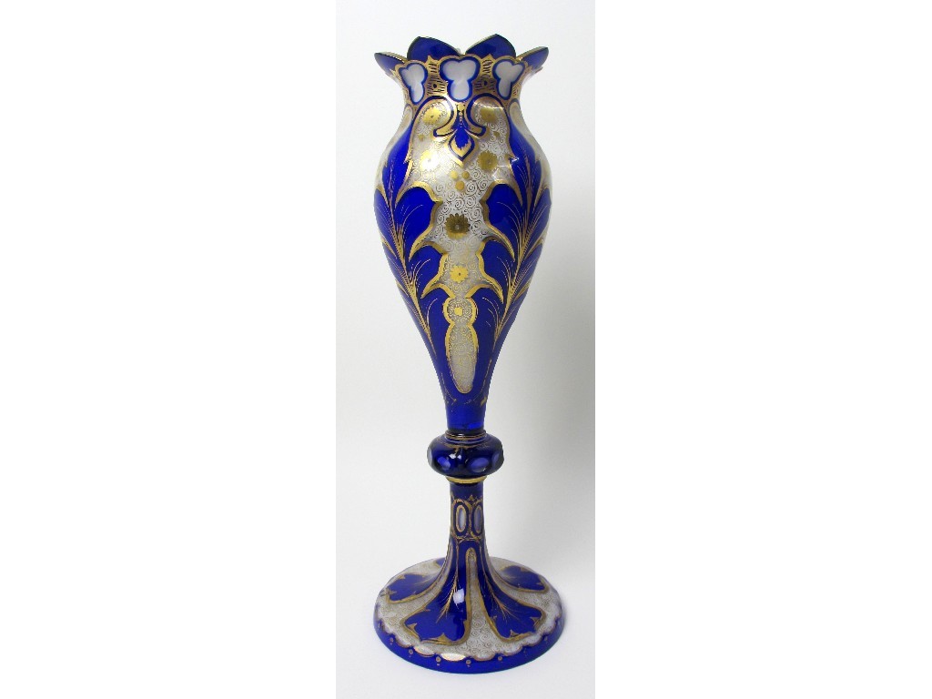 Appraisal: A Bohemian blue overlaid and gilt opaque glass vase decorated