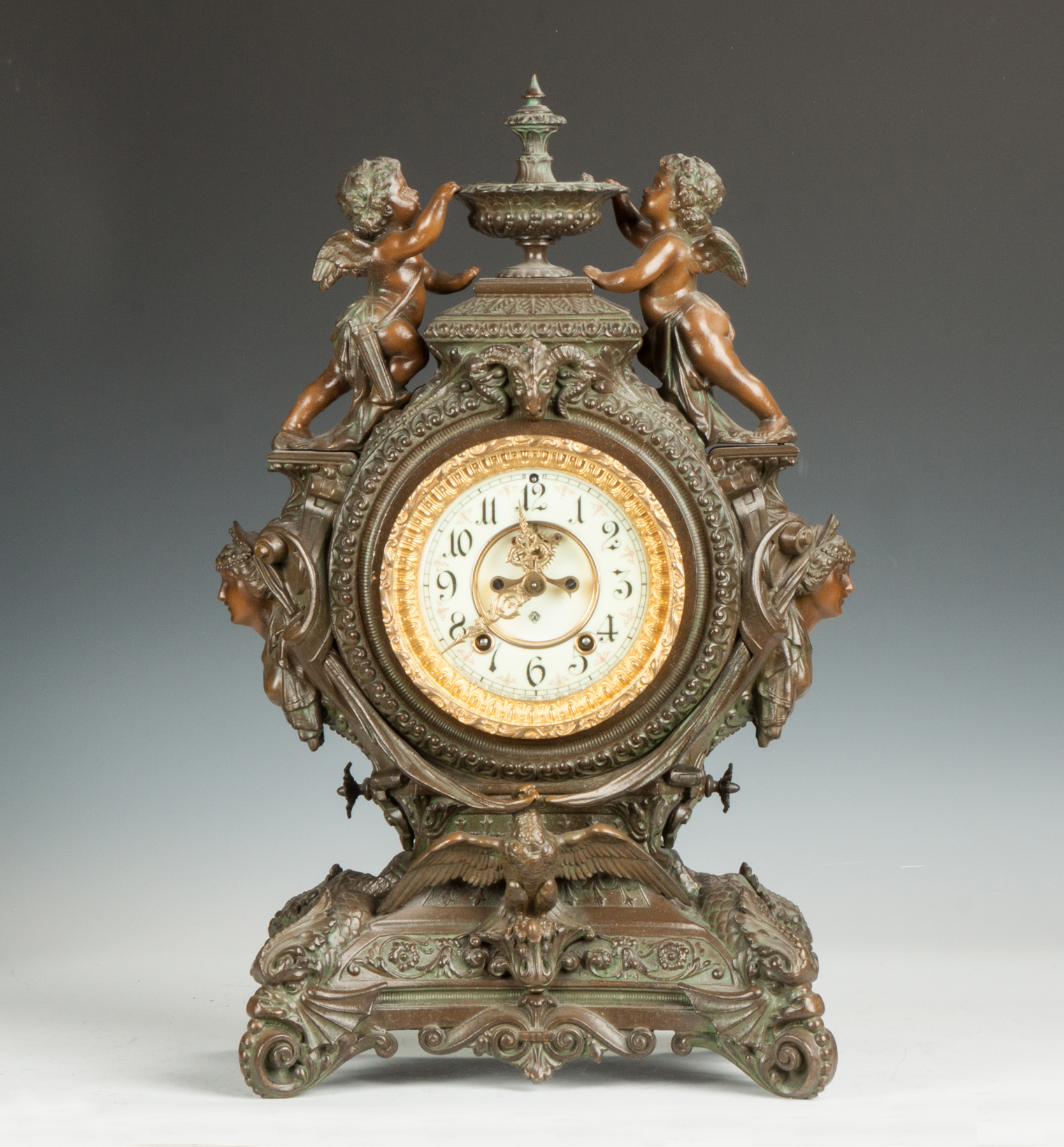 Appraisal: Ansonia Lydia Shelf Clock Patinaed metal with Victorian heads cherubs