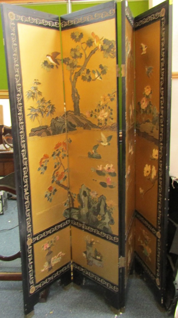 Appraisal: An Oriental lacquer four fold screen with raised decoration birds