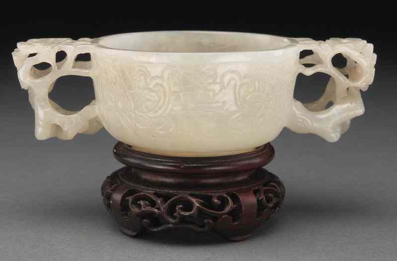 Appraisal: Chinese Ming carved jade libation cup with two handles carved