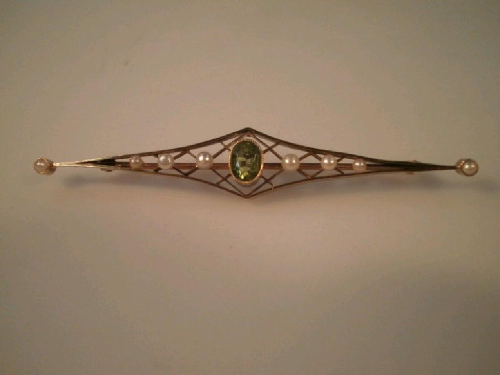 Appraisal: A bar brooch set with peridot and seed pearls stamped