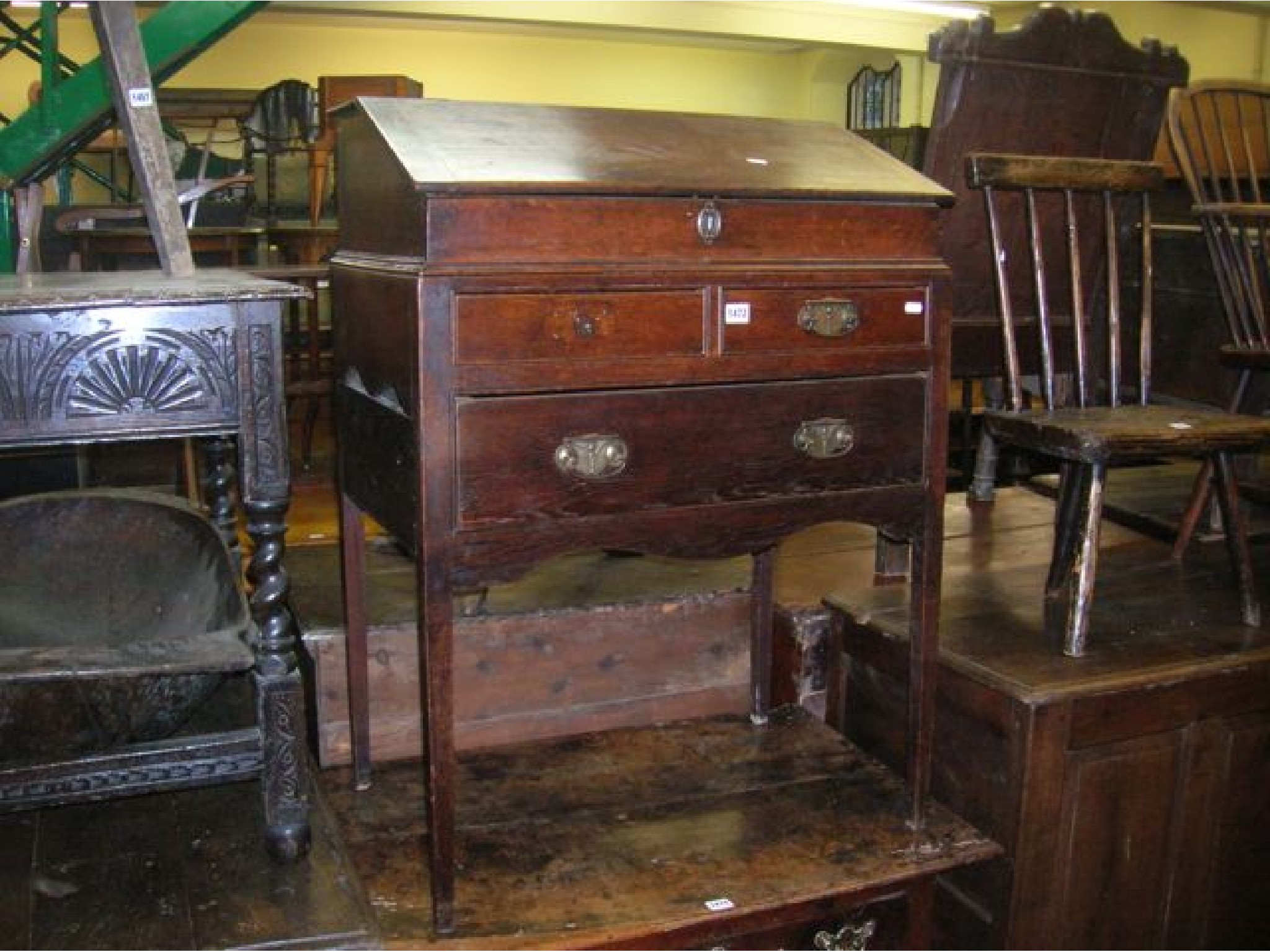 Appraisal: A Georgian oak writing slope with rising lid over an