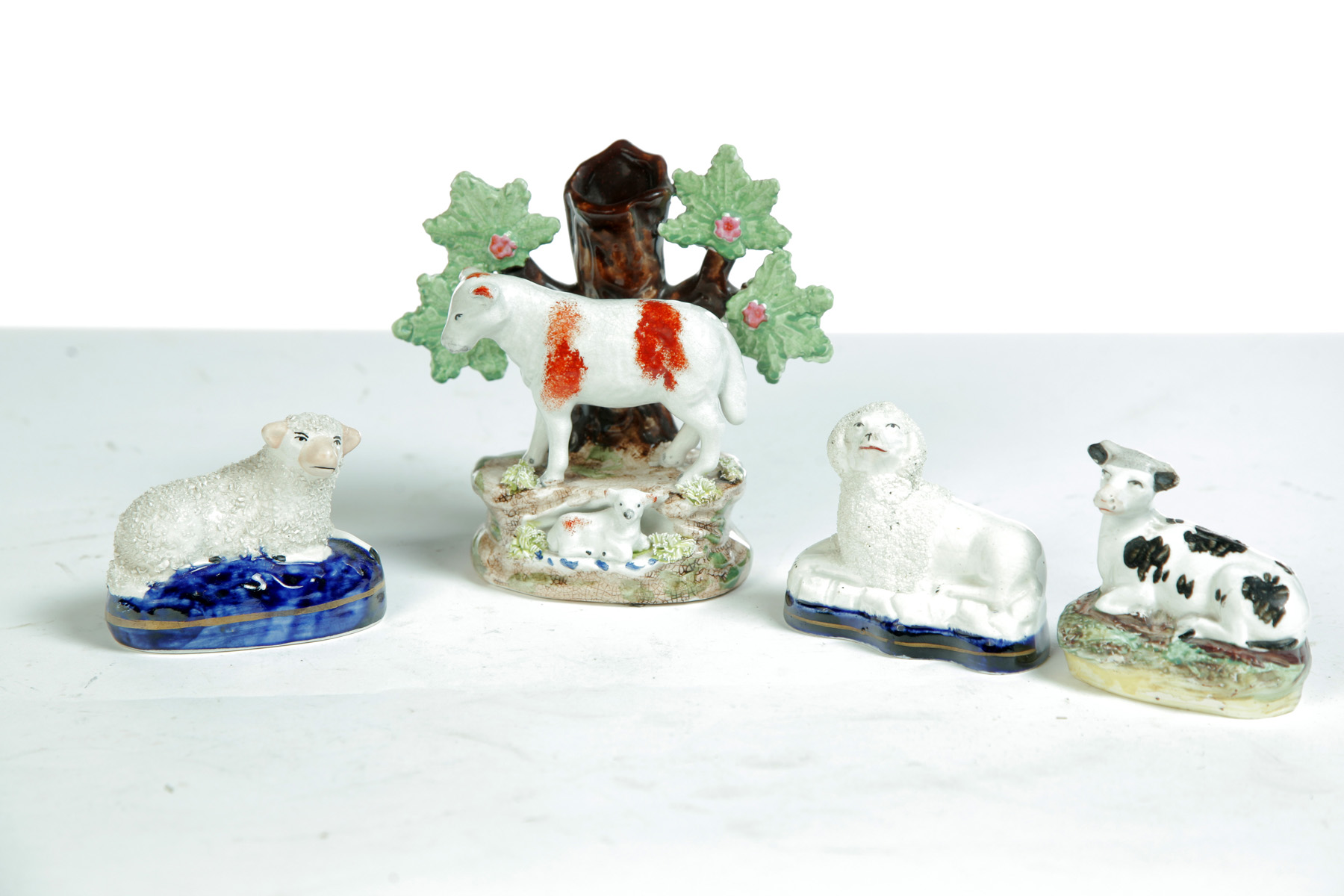 Appraisal: FOUR STAFFORDSHIRE ANIMAL FIGURES England rd quarter- th century Small